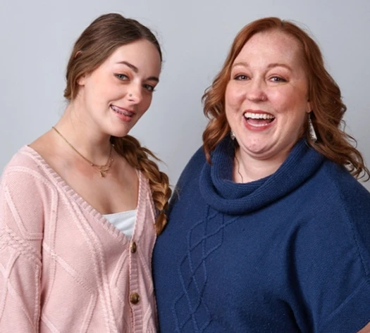 A real patient and caregiver smiling, sharing their story managing eczema with Opzelura.