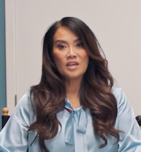 Dr. Lee sitting in a wardrobe and makeup room, discussing how she manages eczema with Opzelura.