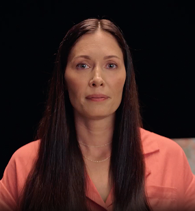 Emily in front of a black background, discussing how she managed eczema with Opzelura.