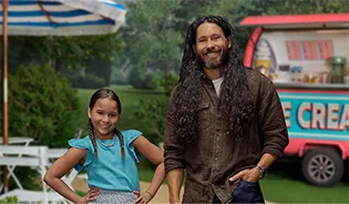 Piper and Adam standing in a park setting in front of an ice cream cart sharing their Moments of Clarity, discussing Piper's management of mild to moderate eczema with Opzelura.