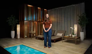 A real patient smiling in a spa, sharing their story managing their vitiligo with Opzelura.